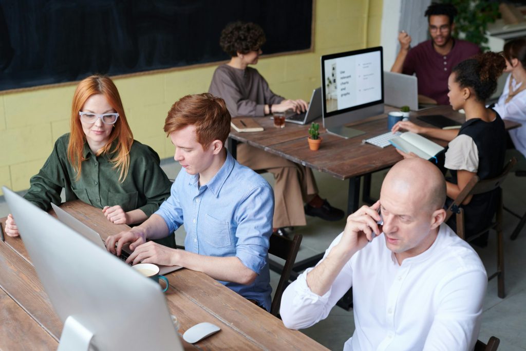 pexels-photo-3182748-3182748 A busy team of professionals collaborating in a modern office space during the day.