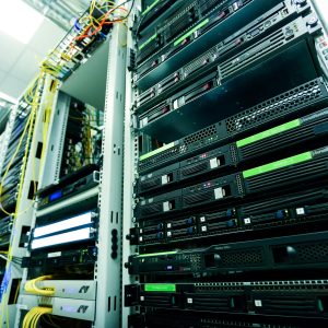 High-tech server rack in a secure data center with network cables and hardware components.