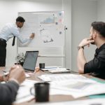 Colleagues in a business meeting discussing data and strategies at the office.
