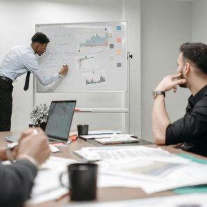 Colleagues in a business meeting discussing data and strategies at the office.